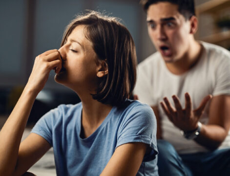 I don't know how much longer I can stand this relationship! Depressed woman feeling unhappy in a relationship with her boyfriend and ignoring him while he is yelling at her.